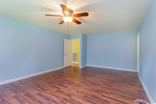 spare room with dark wood-type flooring, a textured ceiling, and ceiling fan