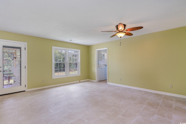 unfurnished room with ceiling fan and washer / clothes dryer