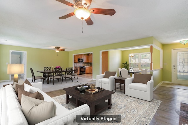 living room featuring hardwood / wood-style floors and ceiling fan