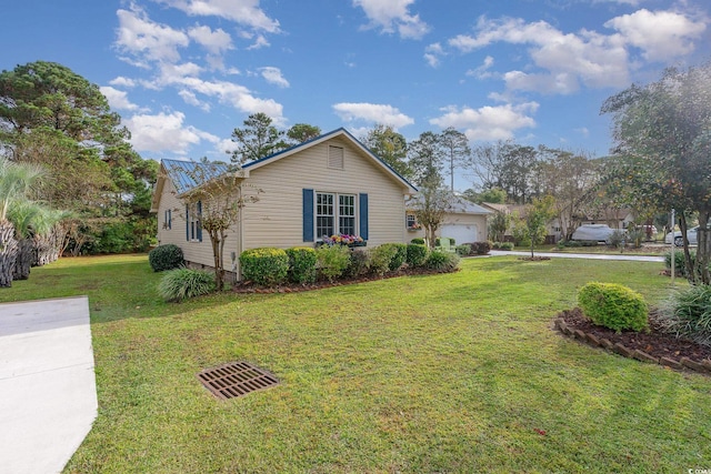 view of home's exterior with a garage and a lawn