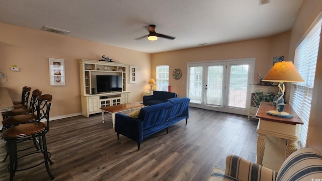 living room featuring dark hardwood / wood-style flooring and ceiling fan