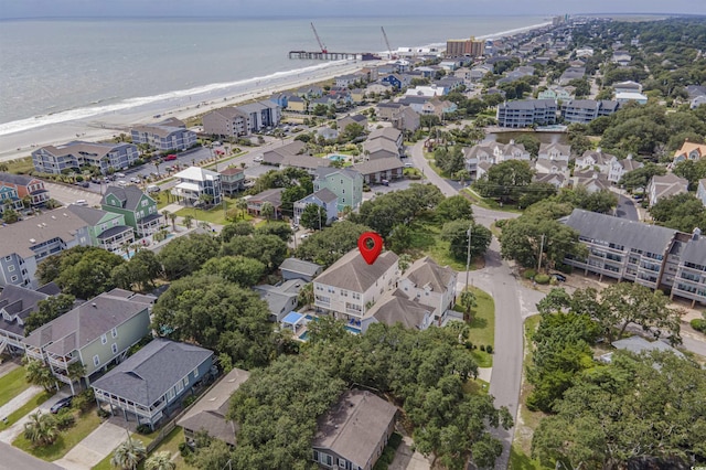 drone / aerial view with a water view and a beach view