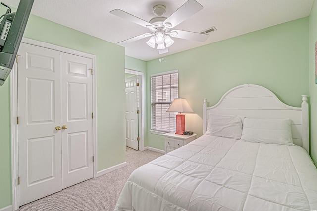 bedroom with light carpet and ceiling fan