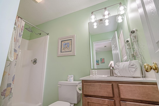 bathroom with a shower with curtain, vanity, toilet, and a textured ceiling