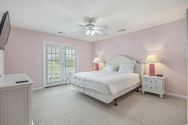 bedroom featuring ceiling fan, access to exterior, light carpet, and a textured ceiling