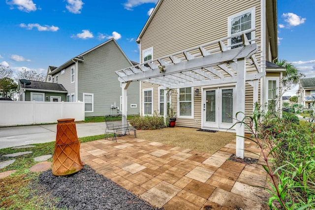 rear view of house featuring a patio and a pergola