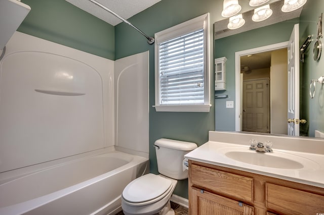 full bathroom featuring vanity, a textured ceiling, toilet, and shower / washtub combination