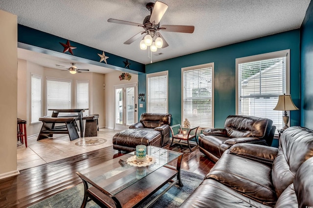 living room with plenty of natural light, light hardwood / wood-style flooring, and a textured ceiling