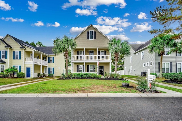 view of front of home featuring a balcony and a front yard