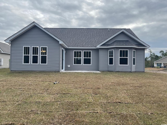 back of property featuring a yard and a patio area