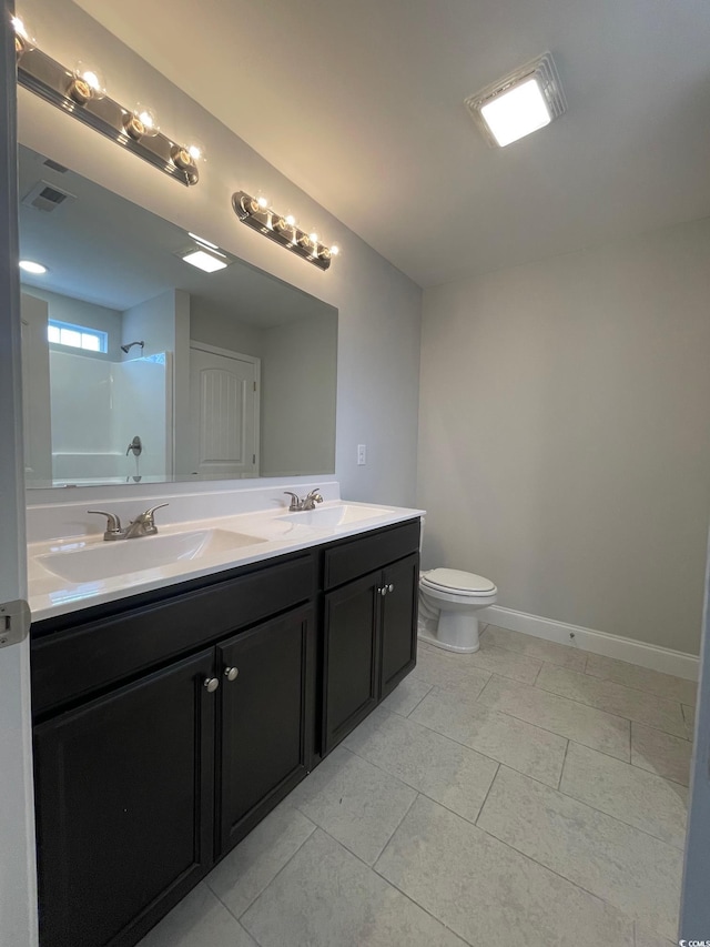 full bathroom featuring tile patterned flooring, vanity, shower / bath combination, and toilet