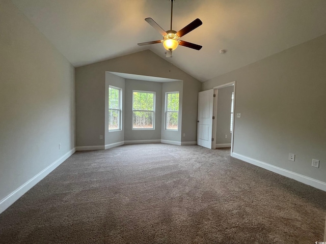 carpeted empty room featuring vaulted ceiling and ceiling fan