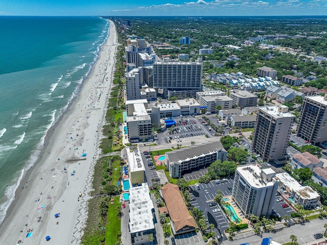 bird's eye view with a water view and a beach view