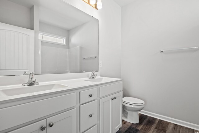 bathroom featuring vanity, toilet, and hardwood / wood-style floors