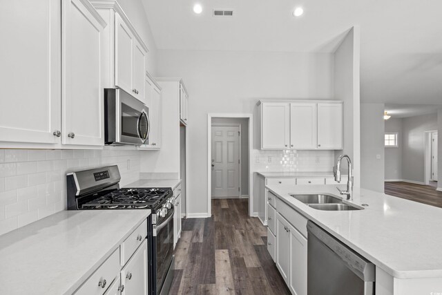 kitchen featuring stainless steel appliances, white cabinetry, and sink