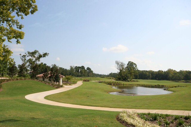 view of community with a lawn and a water view