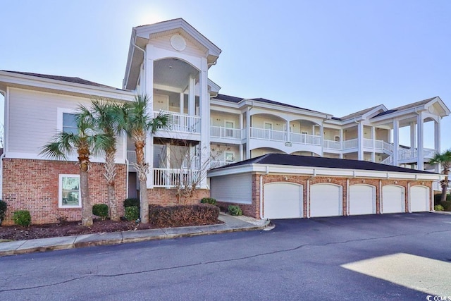 view of front of home with a garage and a balcony