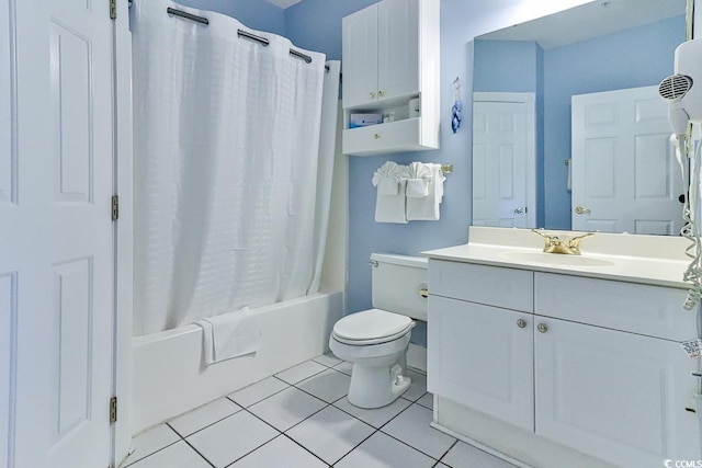 full bathroom with toilet, vanity, tile patterned floors, and shower / tub combo