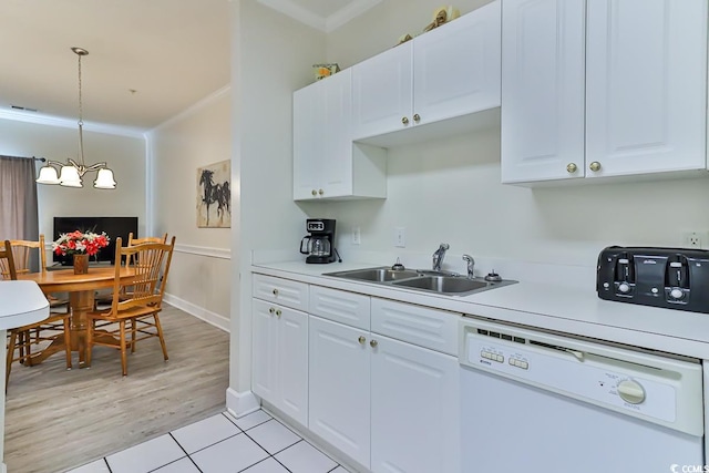 kitchen featuring dishwasher, white cabinets, sink, and crown molding