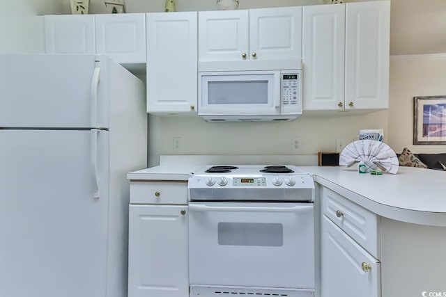 kitchen with white appliances, white cabinetry, kitchen peninsula, and crown molding