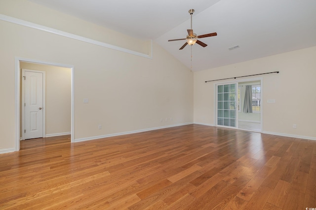 spare room featuring light hardwood / wood-style floors, high vaulted ceiling, and ceiling fan