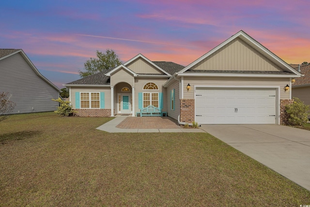 view of front facade with a garage and a lawn