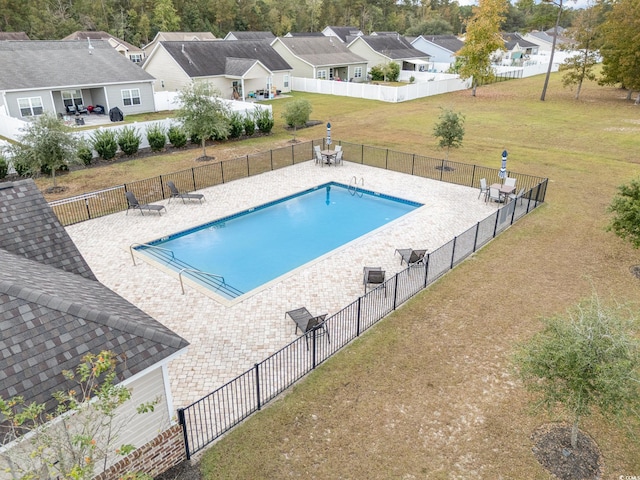 view of swimming pool with a lawn and a patio area