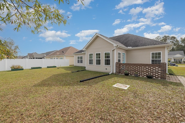 back of house featuring a yard