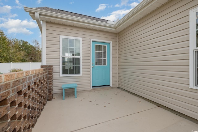 view of exterior entry featuring a patio area