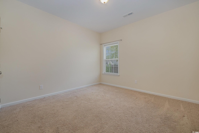 unfurnished room featuring carpet