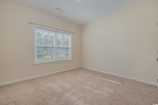 spare room with light colored carpet