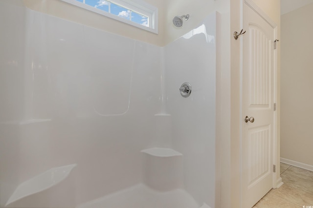 bathroom with tile patterned floors and a shower