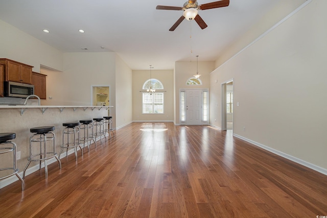 living room with dark hardwood / wood-style flooring and ceiling fan