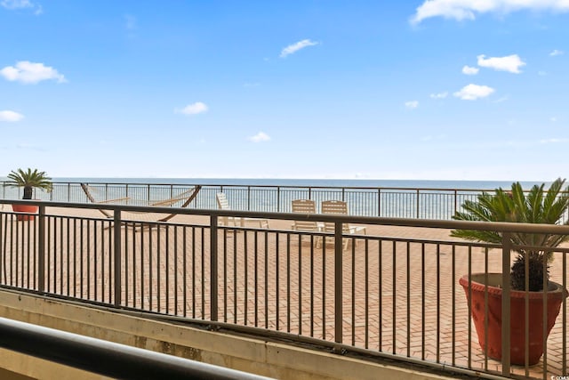 exterior space featuring a beach view and a water view