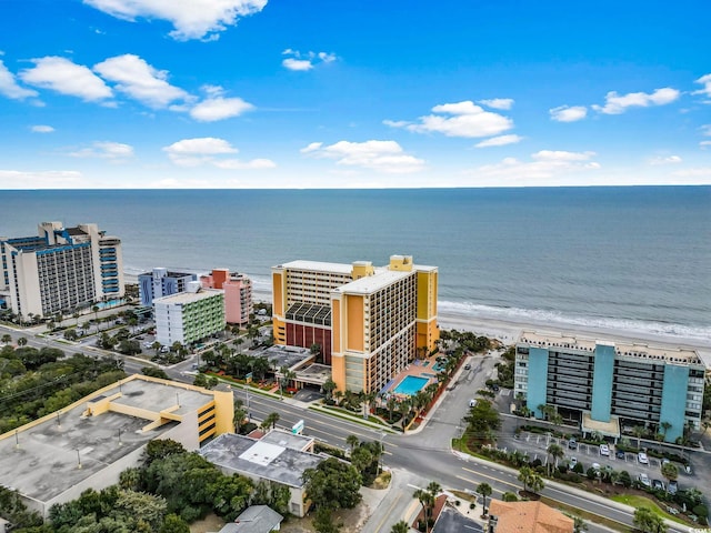 aerial view with a water view and a beach view