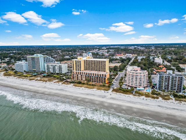 birds eye view of property with a beach view and a water view