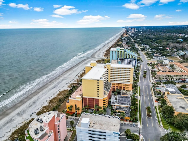 drone / aerial view featuring a beach view and a water view