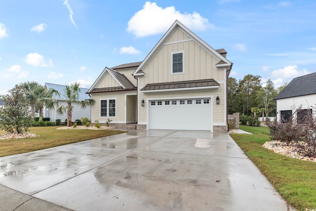 view of front facade featuring board and batten siding, a front yard, driveway, an attached garage, and a standing seam roof