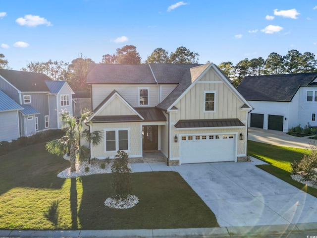 view of front facade with a standing seam roof, board and batten siding, concrete driveway, an attached garage, and a front yard