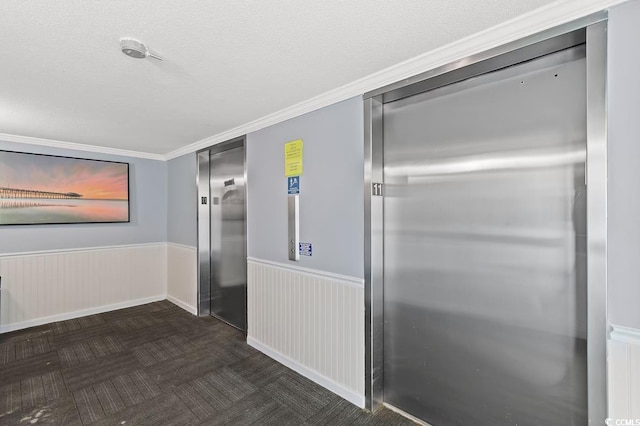 corridor with a textured ceiling and elevator