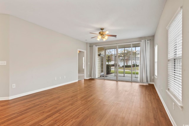 empty room with hardwood / wood-style flooring and ceiling fan