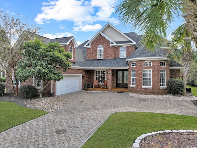 view of front of house with a garage and a front lawn