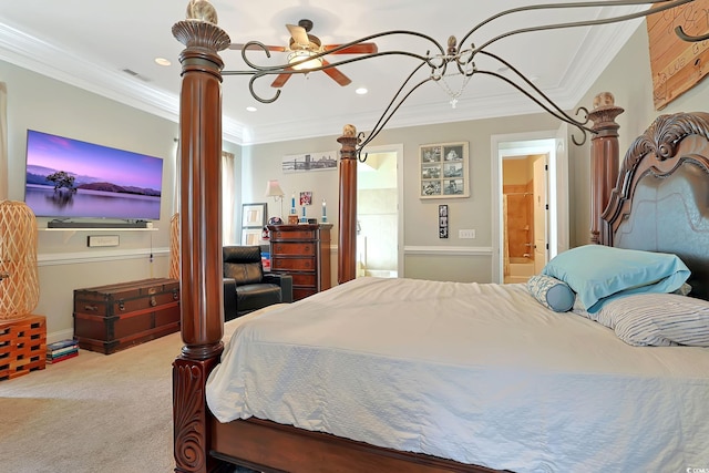 carpeted bedroom with ceiling fan, crown molding, and ensuite bath