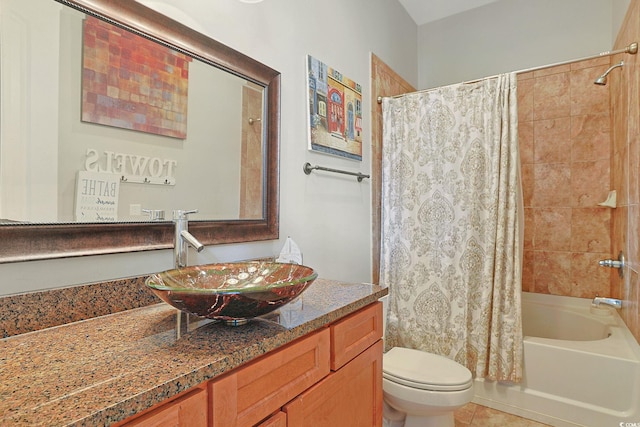 full bathroom with shower / bath combo, tile patterned flooring, vanity, and toilet