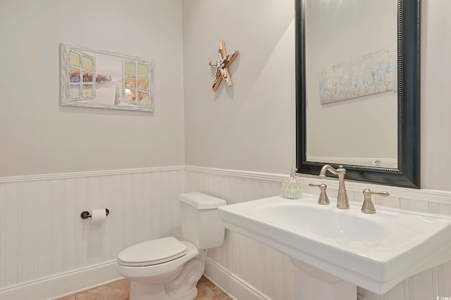 bathroom with tile patterned flooring and toilet