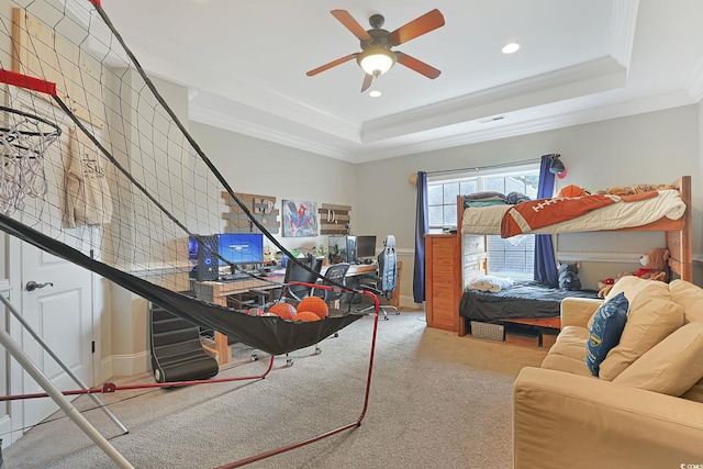 bedroom with ceiling fan, crown molding, a raised ceiling, and carpet floors