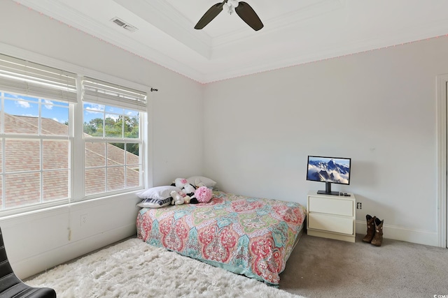 carpeted bedroom featuring ceiling fan and crown molding