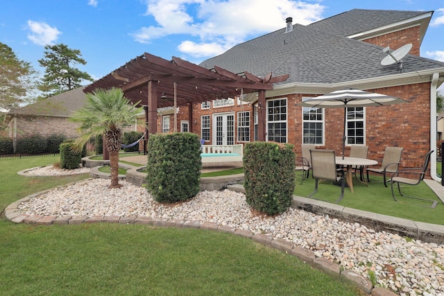 rear view of property with a lawn, a pergola, and a patio area