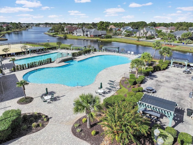 view of pool featuring a patio and a water view