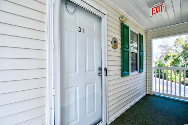 view of exterior entry featuring a porch